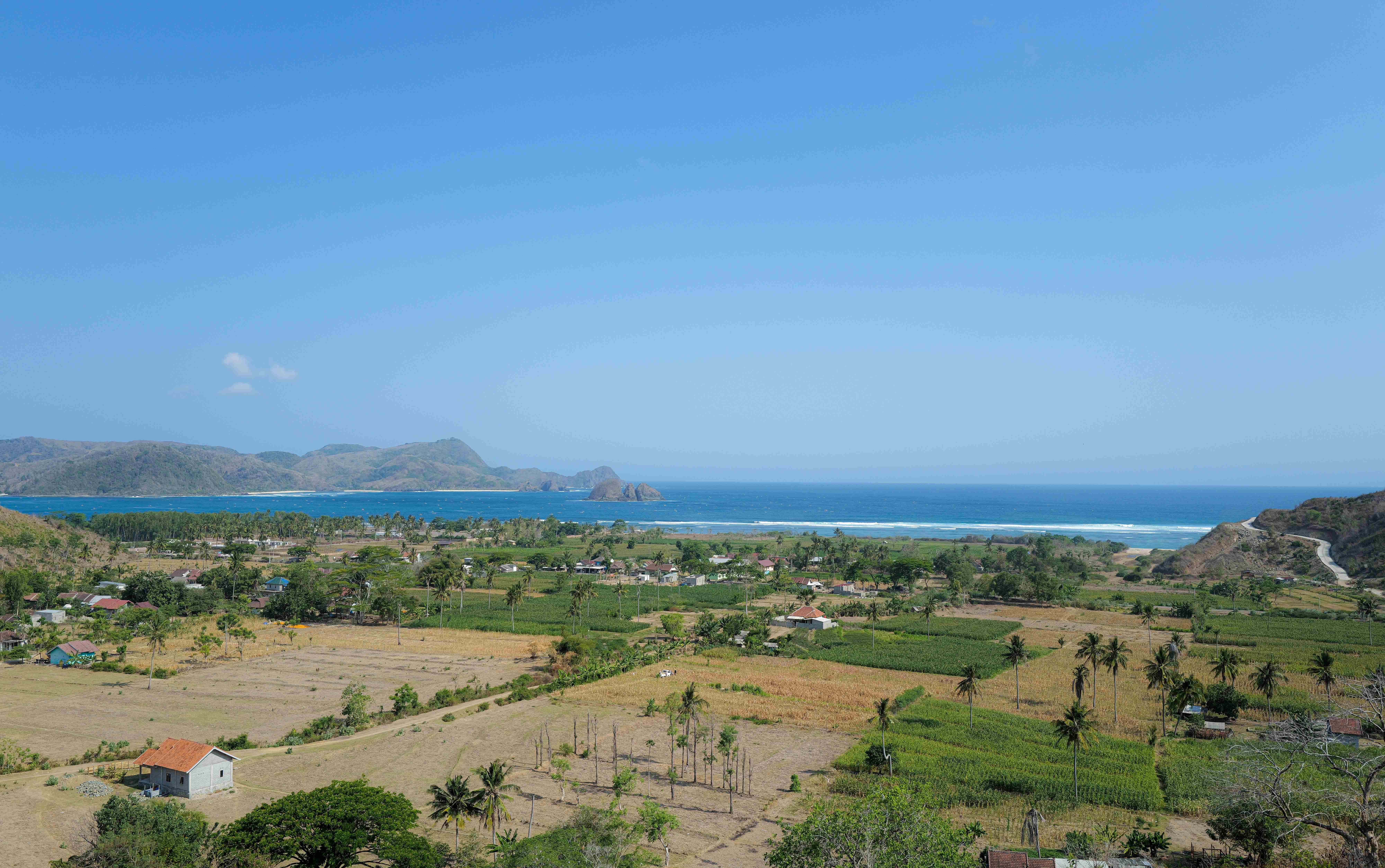 Panoramic view of the Kopal site showing ocean, hills, and natural landscape
